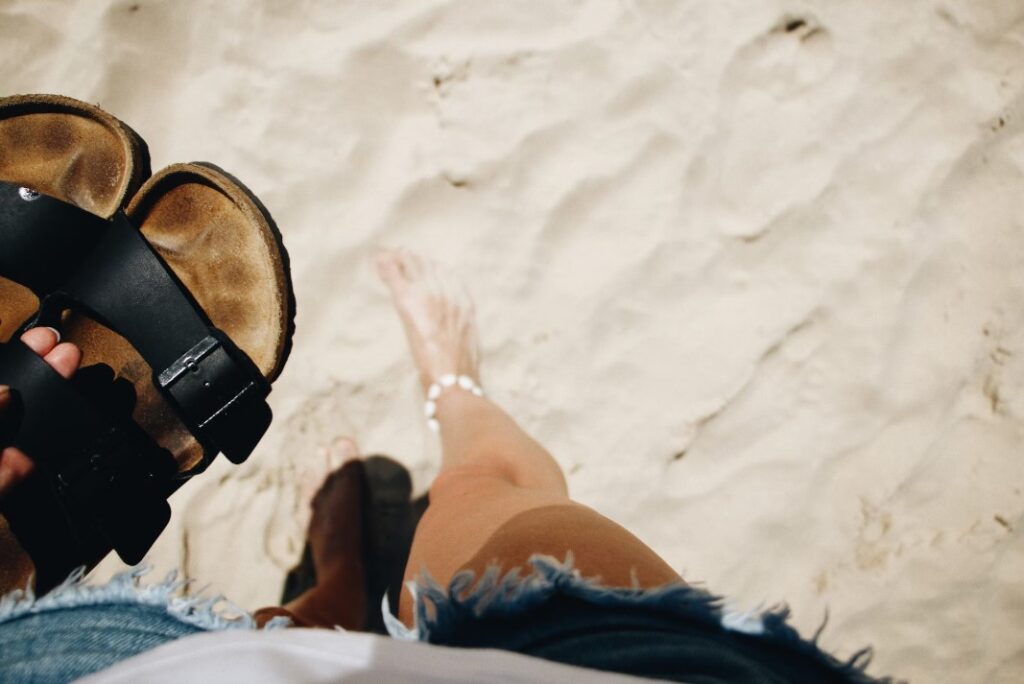 Birkenstock-Sandalen, ausgezogen am Strand