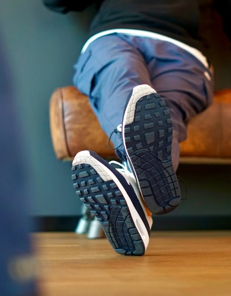 Eine Person, die mit hochgelegten Füßen auf einem Stuhl sitzt